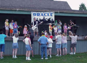 Click for enlarged view. Kids on stage with Oracle