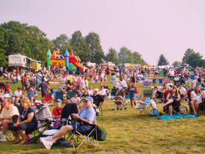 More people pour onto the field to listen to the Oracle Band perform prior to the fireworks in Laurel Maryland