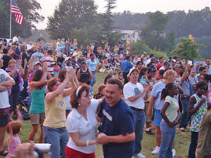 Dancers down in front of the stage as the sun continues to set