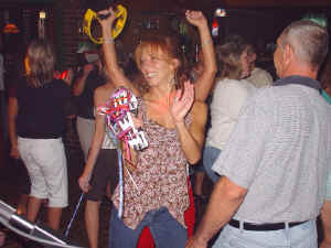 Party people n the dance floor playing tambourine with Oracle Band at Perry's Restaurant