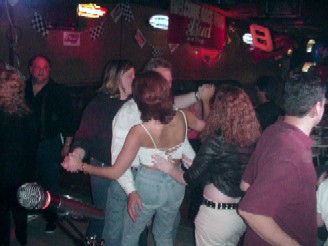 Click for enlarged view. A dance floor sandwich at Jim's Hideaway - lucky guy!